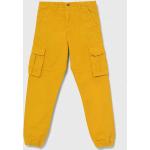 Dětské kalhoty Chlapecké v žluté barvě z bavlny od značky Guess z obchodu Answear.cz s poštovným zdarma 